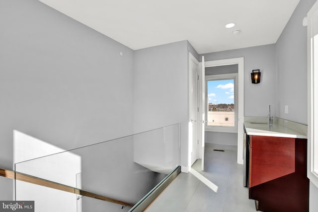 bathroom with a sink and recessed lighting