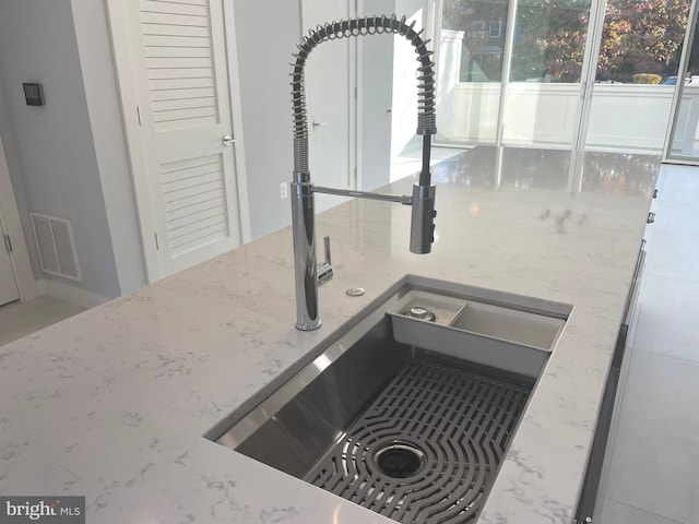 kitchen view of a sink and light stone countertops