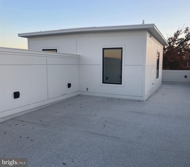 view of side of home featuring a patio