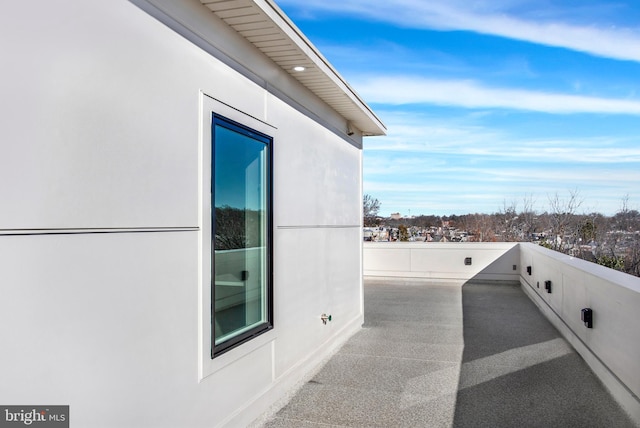 view of side of home featuring a balcony