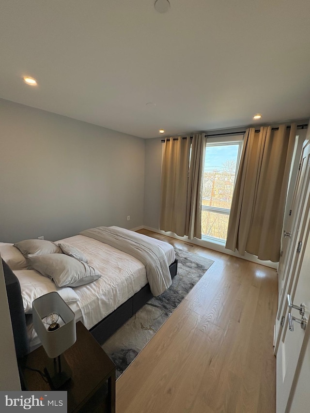 bedroom featuring light wood finished floors and recessed lighting