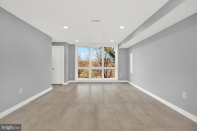 unfurnished living room with recessed lighting, baseboards, and finished concrete floors