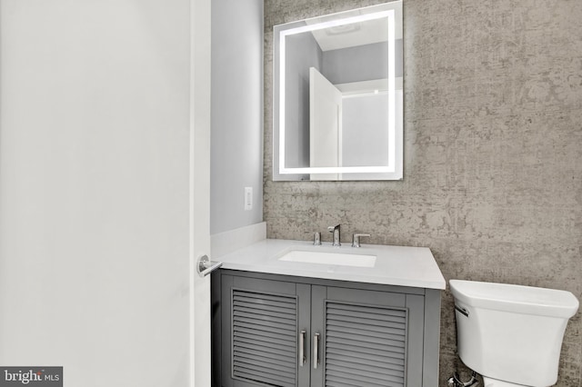 bathroom with vanity and toilet