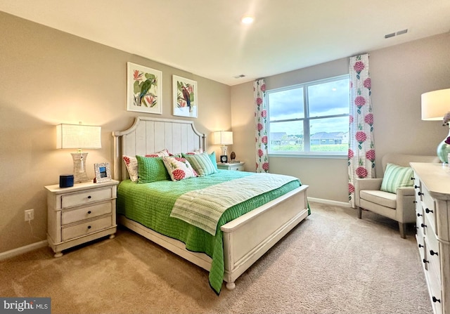 bedroom featuring light colored carpet