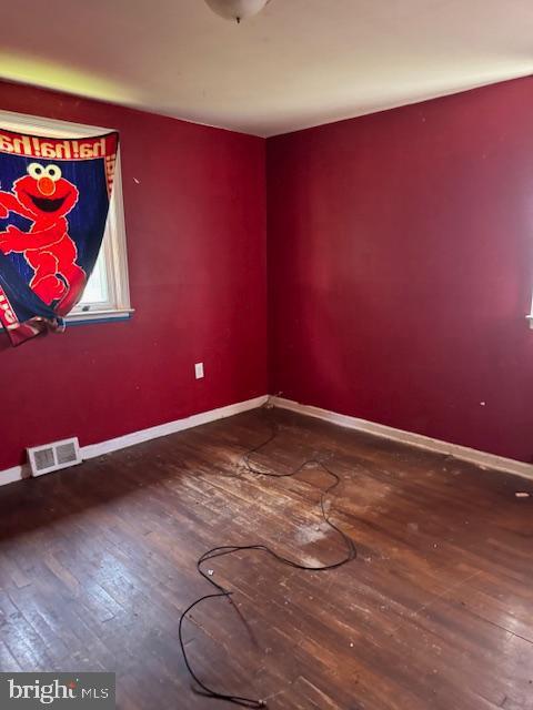 spare room with wood-type flooring