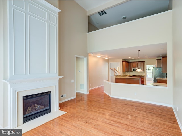 unfurnished living room with light hardwood / wood-style floors and a fireplace