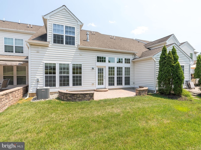 back of house featuring a lawn, central AC, and a patio area