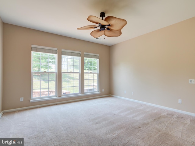 empty room featuring ceiling fan and light colored carpet