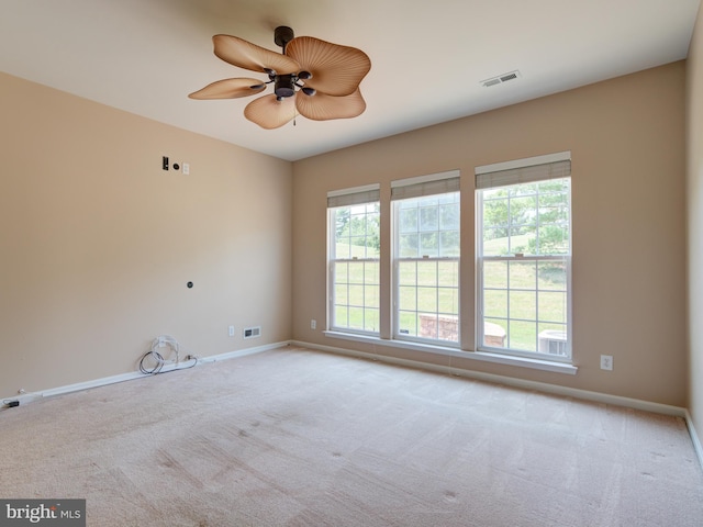 carpeted spare room with ceiling fan