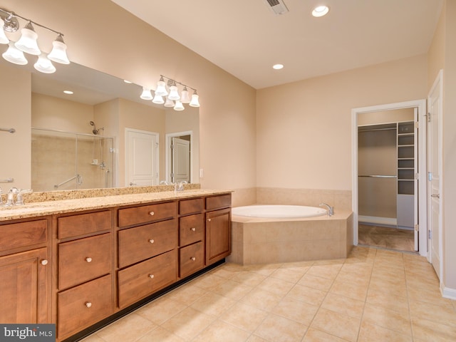 bathroom with independent shower and bath, tile patterned flooring, and vanity