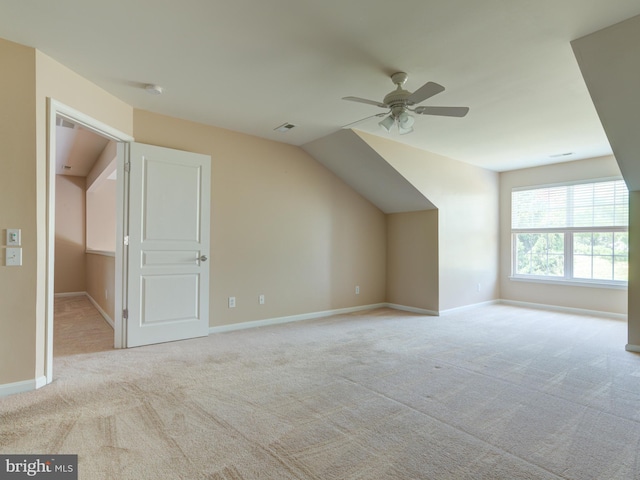 additional living space with ceiling fan, light colored carpet, and lofted ceiling