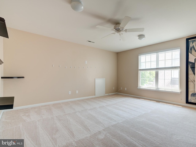 spare room featuring ceiling fan and light colored carpet