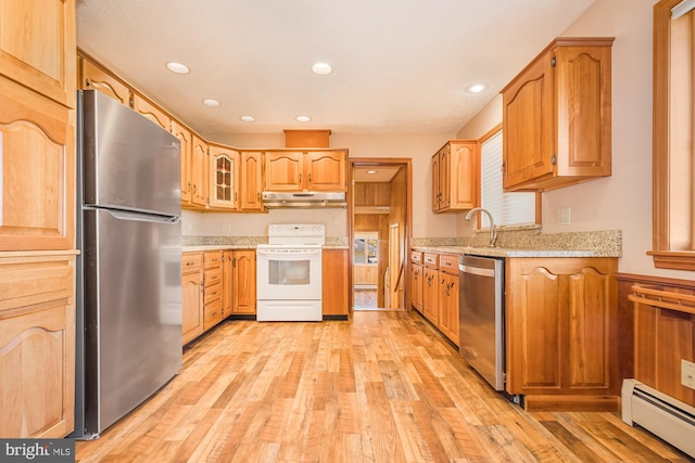 kitchen with baseboard heating, appliances with stainless steel finishes, light hardwood / wood-style flooring, and sink