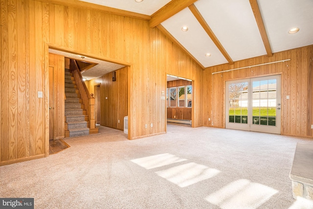 carpeted living room with a baseboard heating unit, wooden walls, and lofted ceiling with beams