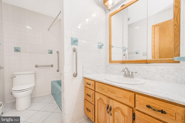 full bathroom with toilet, shower / washtub combination, tile walls, tile patterned floors, and vanity