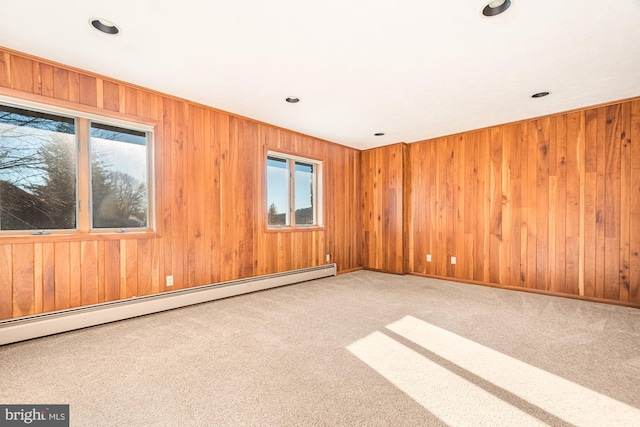 spare room featuring carpet and baseboard heating