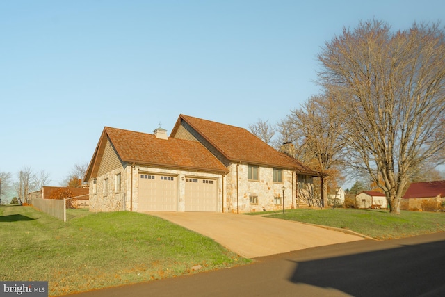 view of front of home with a front lawn and a garage