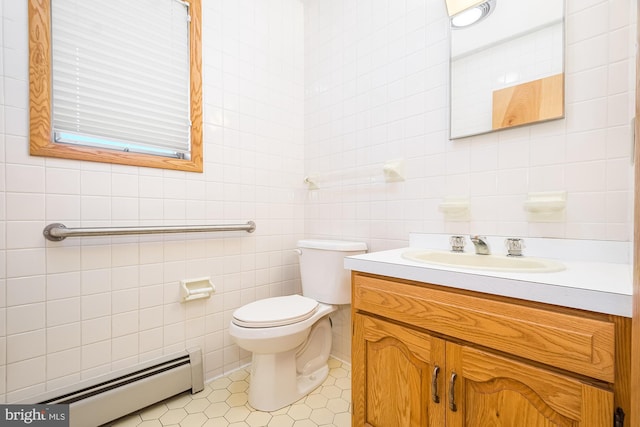 bathroom featuring toilet, a baseboard radiator, tile walls, tile patterned floors, and vanity