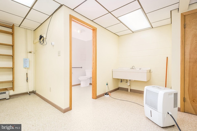 basement featuring sink and a paneled ceiling