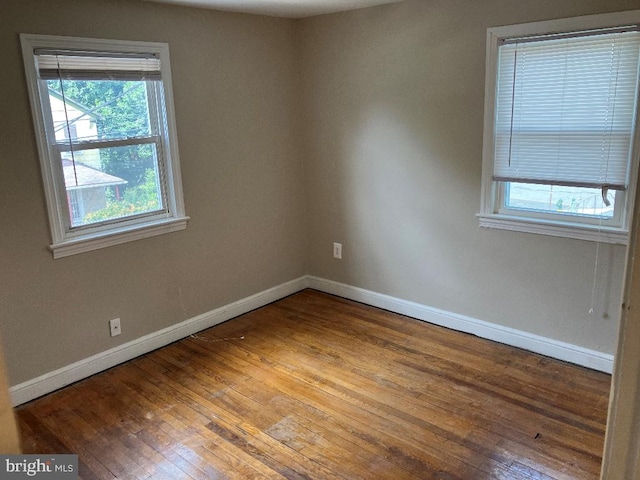 spare room featuring wood-type flooring