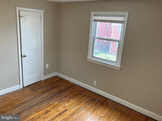 spare room with wood-type flooring