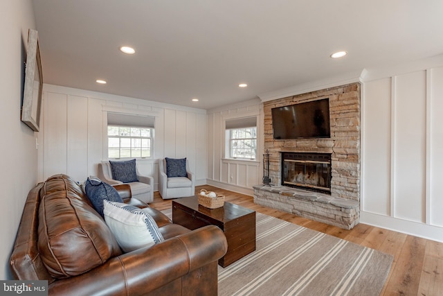 living room featuring a fireplace and light hardwood / wood-style flooring