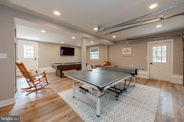 recreation room with pool table, light hardwood / wood-style flooring, and a healthy amount of sunlight