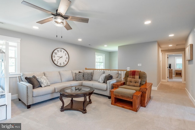 living room with light colored carpet and ceiling fan