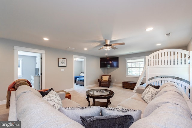 carpeted living room featuring ceiling fan