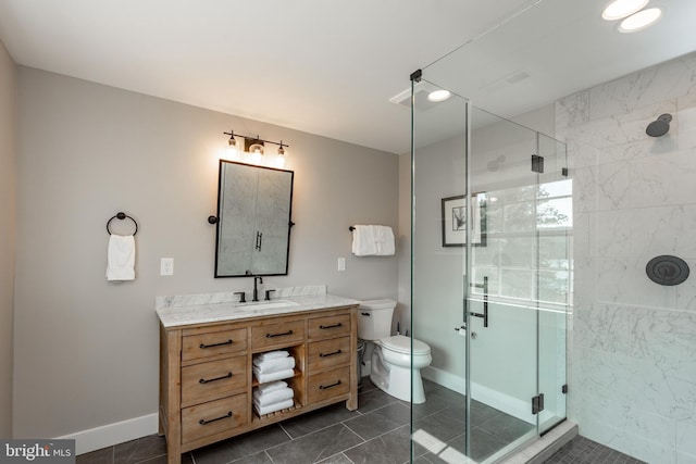 bathroom featuring a shower with door, tile patterned flooring, vanity, and toilet