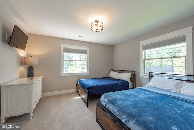 bedroom featuring light carpet