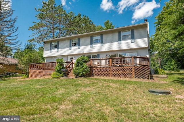 back of house with a deck and a yard