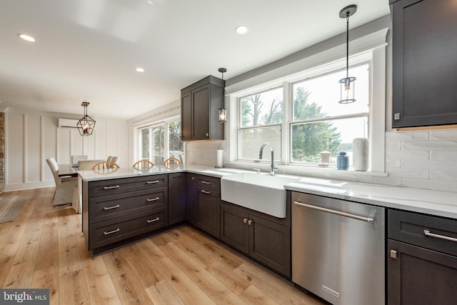 kitchen with pendant lighting, stainless steel dishwasher, and decorative backsplash