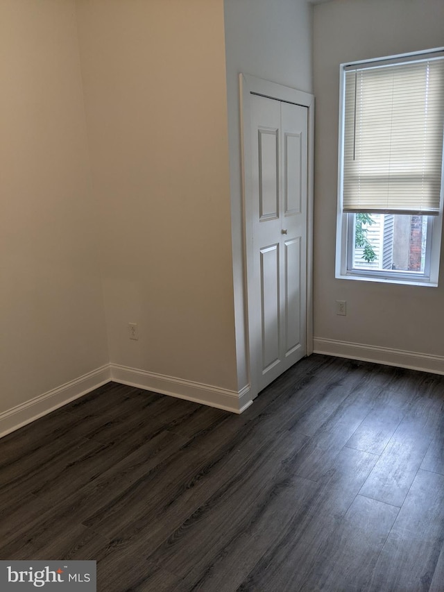 empty room featuring dark hardwood / wood-style flooring