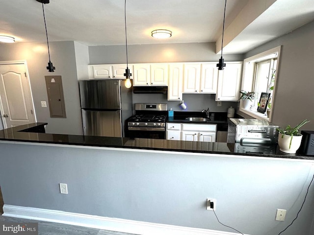 kitchen featuring stainless steel appliances, sink, decorative light fixtures, electric panel, and white cabinetry