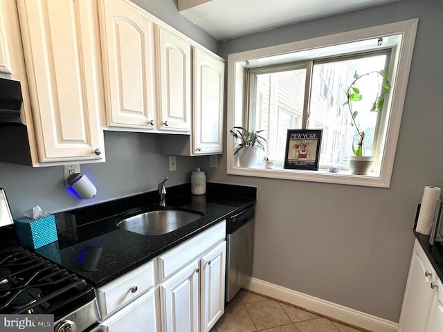 kitchen with white cabinets, gas stove, sink, dishwasher, and light tile patterned flooring