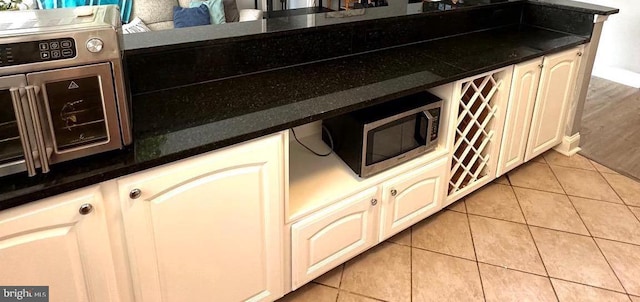 kitchen with light tile patterned flooring