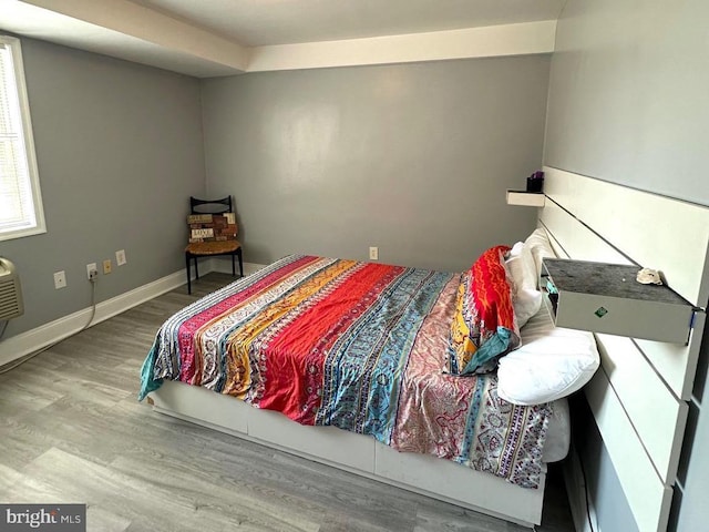 bedroom with wood-type flooring