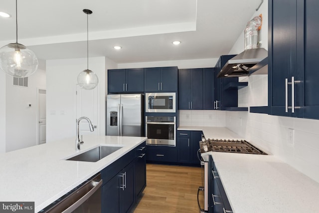 kitchen with appliances with stainless steel finishes, backsplash, blue cabinets, and sink