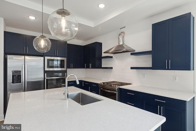 kitchen featuring blue cabinetry, sink, hanging light fixtures, stainless steel appliances, and decorative backsplash