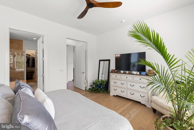 bedroom featuring ceiling fan, connected bathroom, and light hardwood / wood-style floors