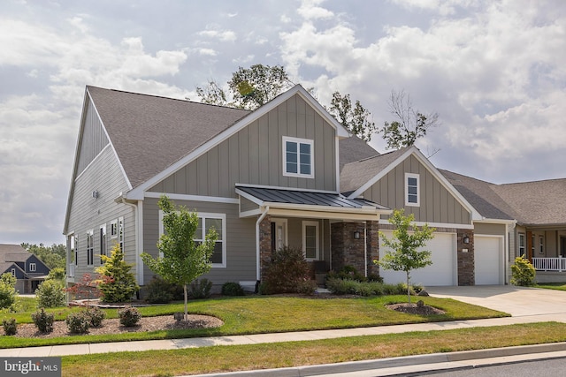 craftsman inspired home featuring a garage and a front yard