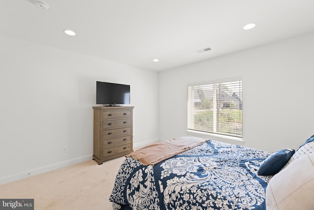 bedroom featuring light colored carpet