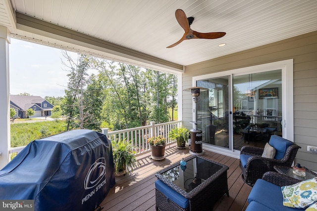 wooden terrace with a grill and ceiling fan