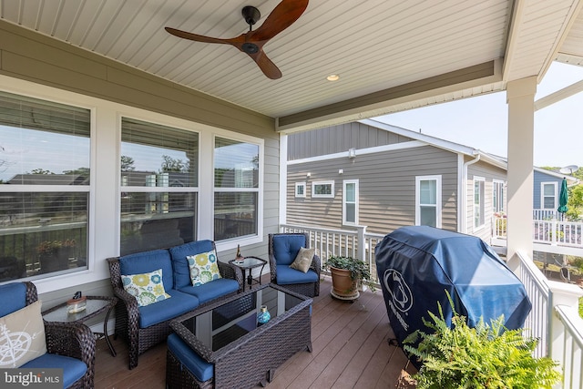 wooden terrace with a grill, outdoor lounge area, and ceiling fan