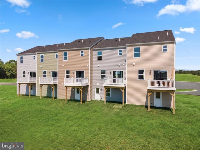 rear view of property with a lawn