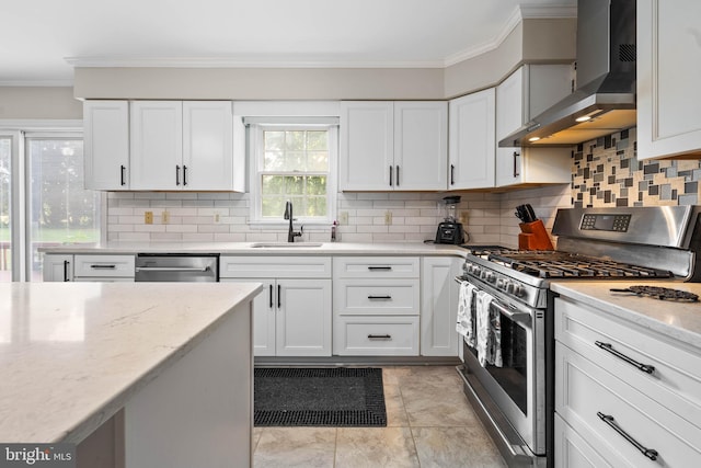 kitchen with stainless steel appliances, sink, light tile patterned floors, decorative backsplash, and wall chimney exhaust hood