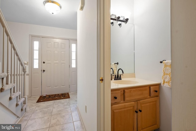 foyer entrance featuring light tile patterned flooring and sink