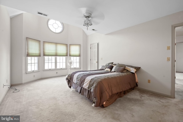 carpeted bedroom featuring ceiling fan and vaulted ceiling