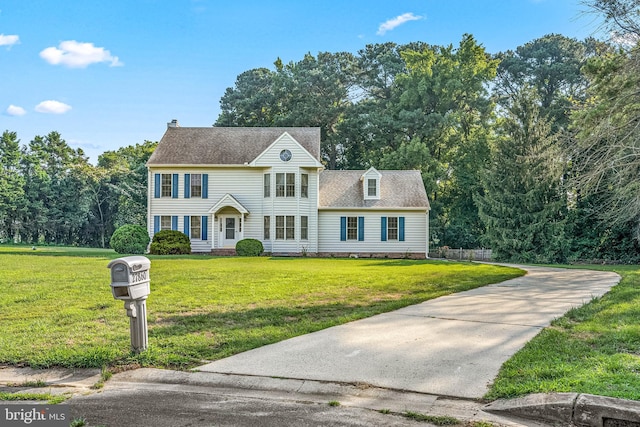 colonial inspired home featuring a front yard